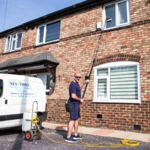 Window cleaner Ged from See Thru cleaning upper floor windows at a domestic property in South Manchester using a water fed pole system.