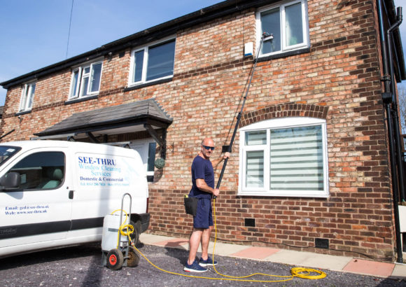 Window cleaner Ged from See Thru cleaning upper floor windows at a domestic property in South Manchester using a water fed pole system.