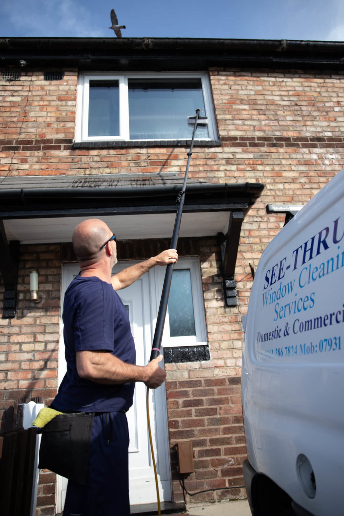 Ged from See Thru Window Cleaning using a water fed pole to clean upper floor windows at a terraced house in South Manchester