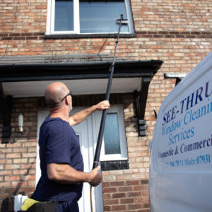 Ged from See Thru Window Cleaning using a water fed pole to clean upper floor windows at a terraced house in South Manchester
