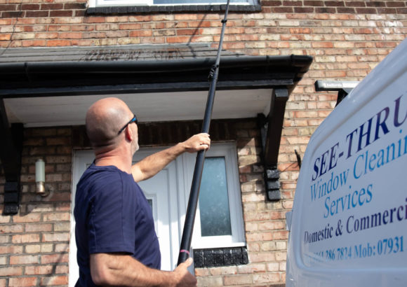 Ged from See Thru Window Cleaning using a water fed pole to clean upper floor windows at a terraced house in South Manchester